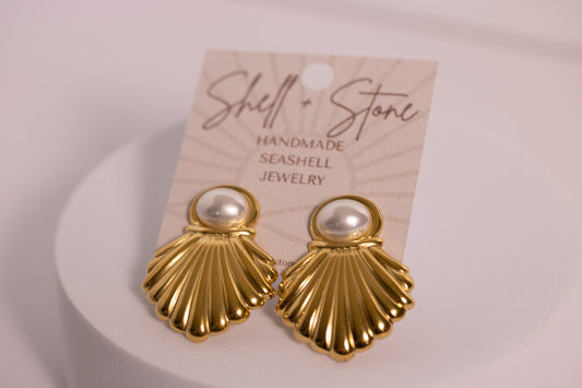Gold shell earrings with pearl centers on a 'Shell & Stone' branded card.